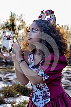 Beautiful girl in vintage red dress with a rose