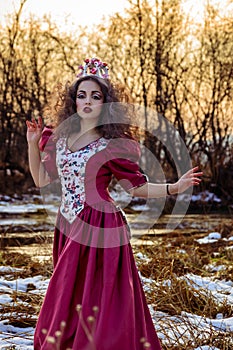 Beautiful girl in vintage red dress with a rose