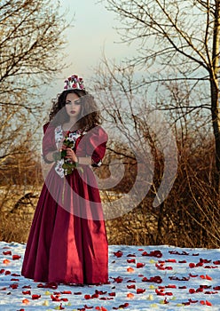 Beautiful girl in vintage red dress with a rose
