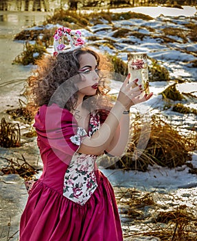 Beautiful girl in vintage red dress with a rose