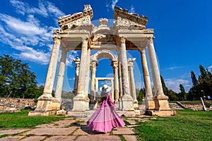 Beautiful girl walking at Aphrodisias ancient city in Turkey. photo