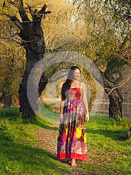 Beautiful girl walking barefoot in the spring nature