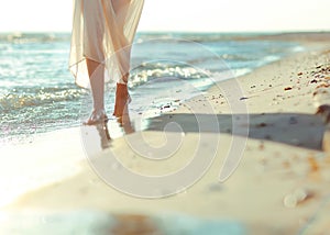 Beautiful girl walking down the beach