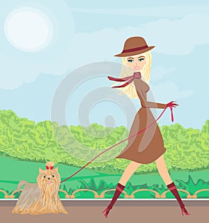 Beautiful girl walking her dog in the park