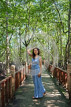 Beautiful girl walking through the mangrove forest in Asia