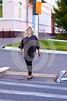 Beautiful girl walking on a pedestrian crossing