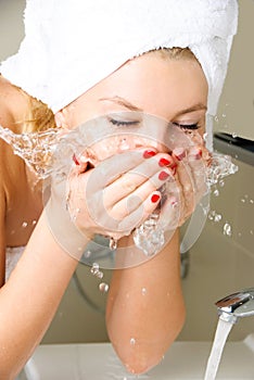 Beautiful girl washing her face