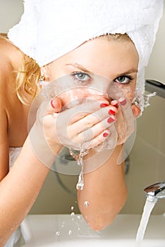 Beautiful girl washing her face