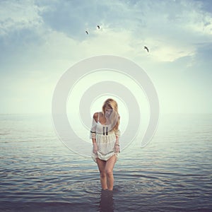 Beautiful girl in the water. Beach, sunrise, cold