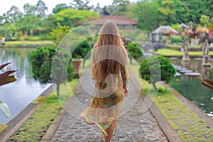 Beautiful girl in the water temple of Inlonesia.