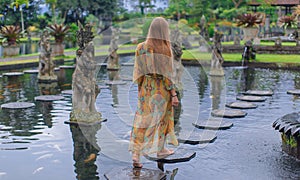 Beautiful girl in the water temple of Inlonesia.