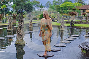 Beautiful girl in the water temple of Inlonesia.