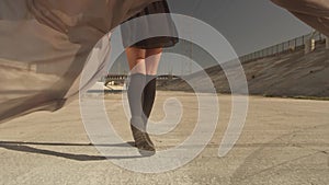 Beautiful girl with the waving fabric positing, dancing, running, walking in the LA River. Industrial area fashion videoshoot.