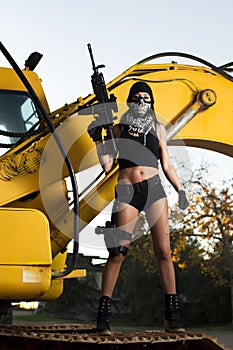 Beautiful girl with weapon and mask