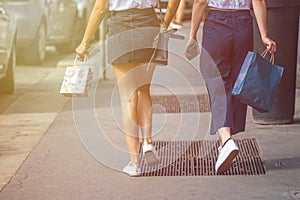 Beautiful girl wearing black mini dress and walking on Milan cit