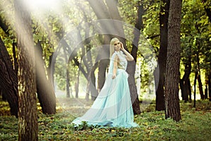 Beautiful girl wearing fairy dress in autumn forest