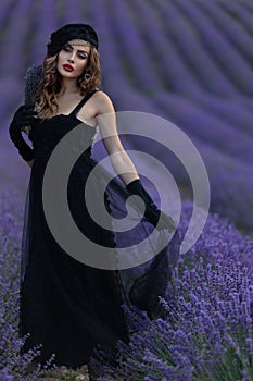 Beautiful girl is wearing fashion dress at field of lavender