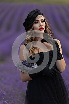 Beautiful girl is wearing fashion dress at field of lavender