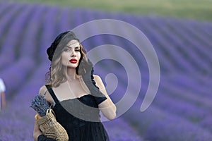 Beautiful girl is wearing fashion dress at field of lavender