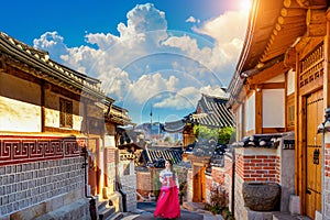 Beautiful girl wearing Korean traditional hanbok at Bukchon Hanok Village. Traditional Korean style architecture in Seoul,Korea photo