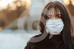 Beautiful Girl Wearing Medical Mask During Coronavirus COVID-19