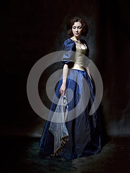 Beautiful girl wearing a medieval dress. Studio works inspired by Caravaggio. Cris. XVII