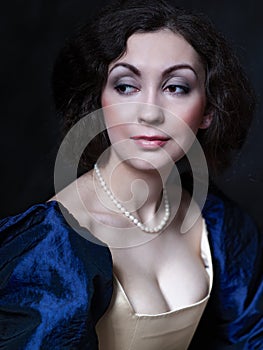 Beautiful girl wearing a medieval dress. Studio works inspired by Caravaggio. Cris. XVII photo