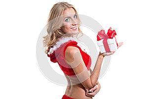 Beautiful girl wearing red santa claus clothes with christmas present gift