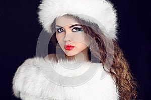 Beautiful Girl wearing in White Fur Coat and Furry Hat. Winter W photo