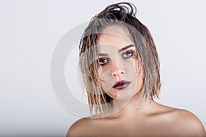 Beautiful girl with wet hair on a white background