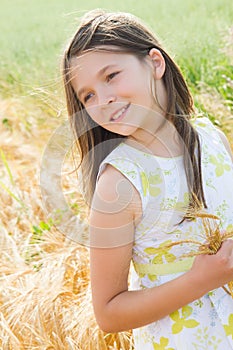 Beautiful girl in the wheat field