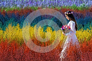 Beautiful girl in white dress sitting in Cutter rainbow flowers fields, Chiang Mai