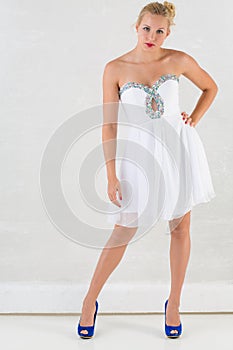 Beautiful girl in white dress in studio with ice