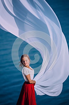 Beautiful Girl With White fabric on sea background