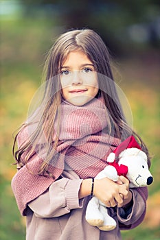 Beautiful girl with white fluffy Christmas teddy bear