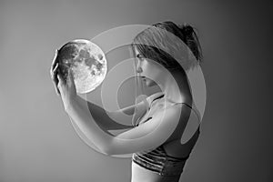 Beautiful girl with white hair holds the moon