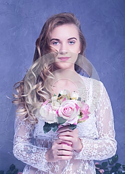 Beautiful Girl in a white peignoir with a bouquet of flowers