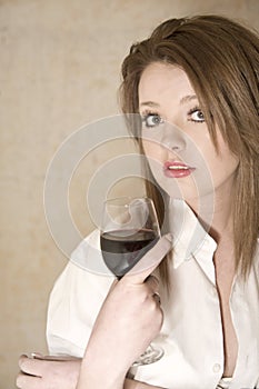 Beautiful girl in white shirt with red wine