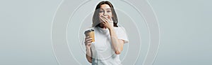 Beautiful girl in white t-shirt with paper cup isolated on grey, panoramic shot