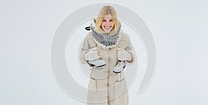 Beautiful girl in the winter outdoors. Beautiful happy laughing young woman wearing winter hat gloves and scarf. Winter