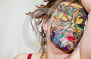 Beautiful girl, woman, body art, drawn drawing on the face close-up.