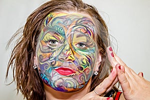 Beautiful girl, woman, body art, drawn drawing on the face close-up.