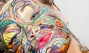 Beautiful girl, woman, body art, drawn drawing on the face close-up.