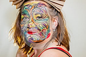 Beautiful girl, woman, body art, drawn drawing on the face close-up.