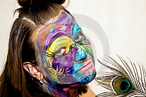 Beautiful girl, woman, body art, drawn drawing on the face close-up.