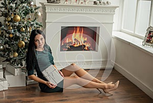 Beautiful girl woman in decorated house, happy new year. New Year Christmas. Girl portrait. Christmas tree. Brunette