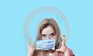 Beautiful girl woman isolated wears a face mask that protects against the spread of coronavirus disease. Surgical mask