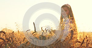 Beautiful girl woman in traditional Bulgarian folklore dress holding golden wheat straws in harvest field, agriculture concept