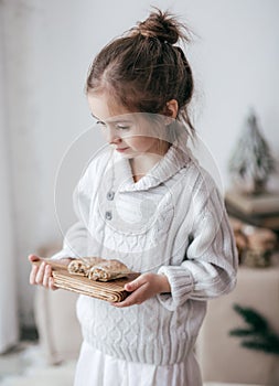 Beautiful girl is with a wooden shelf on which treats