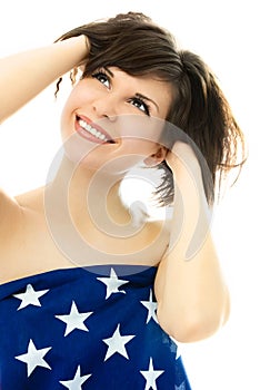 Beautiful girl wrapped into an American flag